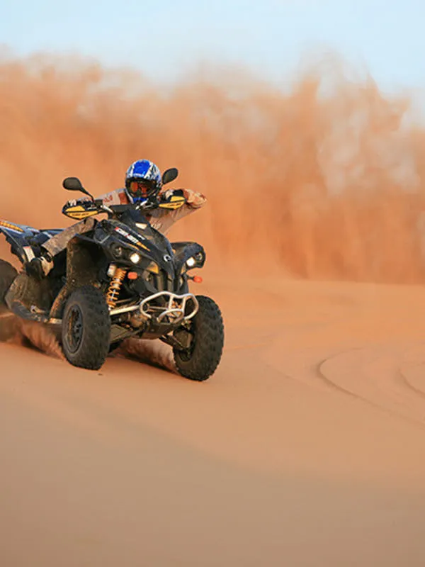 Quad bike ATV rider on Jaisalmer sand dunes