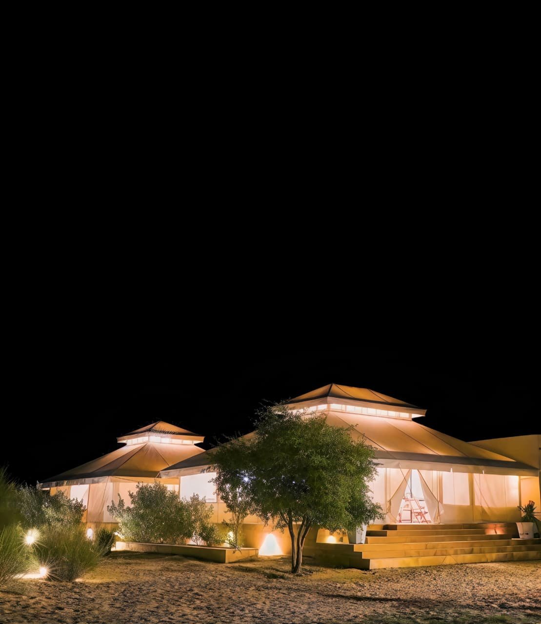 Luxury Swiss tent desert camp at sunset in Jaisalmer
